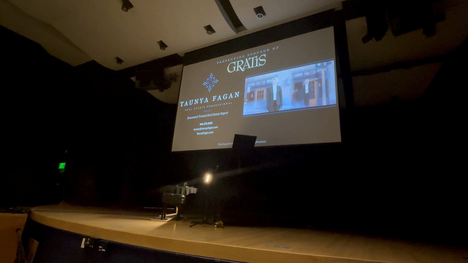 Taunya Fagan Real Estate, presenting sponsor of GRATIS, shown on screen at the concert